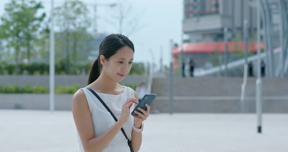 Woman check on cellphone at the station