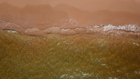 Close Up Sea Splashing with Soft Waves Rushing on Sandy Beachline