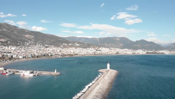 Beautiful city landscape of Alanya with harbor, residential buildings, coastline and mountains