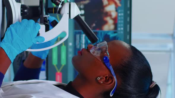 Vertical Video African Woman Biochemist Using Microscope in Laboratory