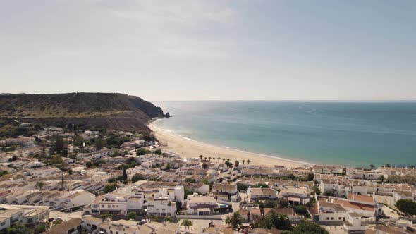 Luz Picturesque town alongside Algarve Coastline, encircling Praia da Luz - Aerial