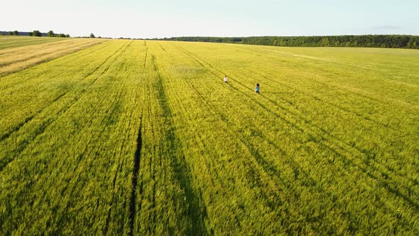 Mother and Son Walking on the Field