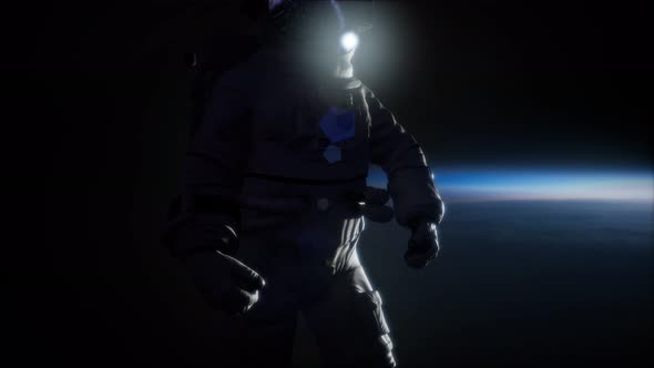 Astronaut in Outer Space Against the Backdrop of the Planet Earth alt
