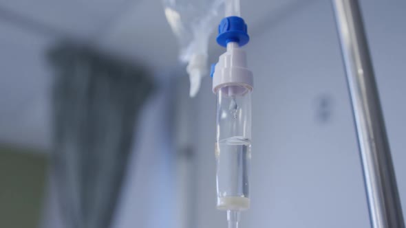 Close up view of dripping medicine in drip equipment working in hospital room