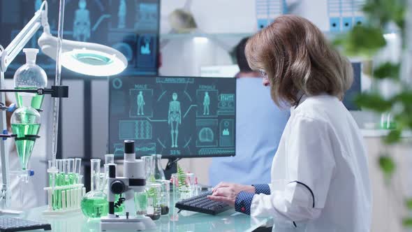 Adult Biologist Workign in Modern Laboratory alt