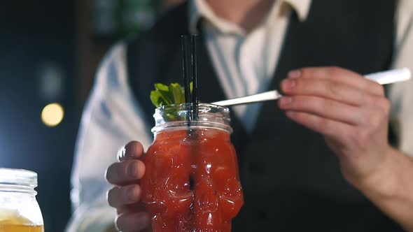 The Bartender Is Preparing an Alcoholic Cocktail.