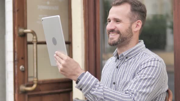 Online Video Chat on Tablet by Young Man