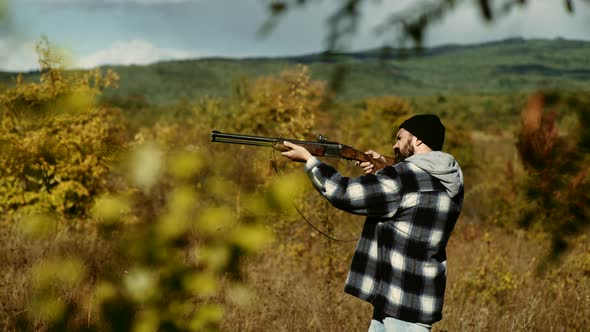 Autumn Hunting Season. Man with Gun. Hunting Licenses. Poacher with Rifle Spotting Some Deers