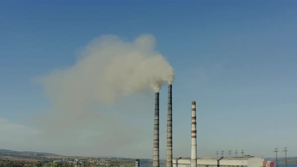 Aerial Drone View of Emission to Atmosphere From Industrial Factory Pipes