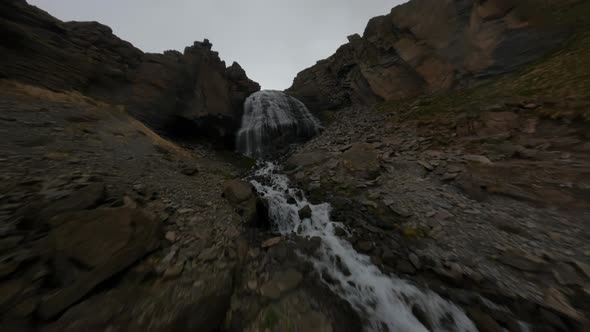 Fast FPV Drone Shot Up Along the Mountain Dew Towards to the Big Waterfall