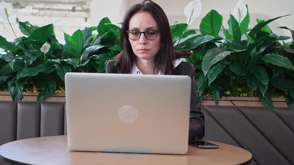 Young Professional Female Manager Using Laptop in Mall Businesswoman Working From Cafe Via Laptop