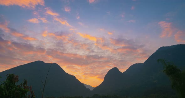 Time lapse sunset colorful sky clouds dramatic mountain landscape valley Laos