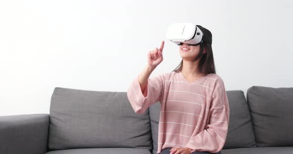 Woman watching with VR device at home