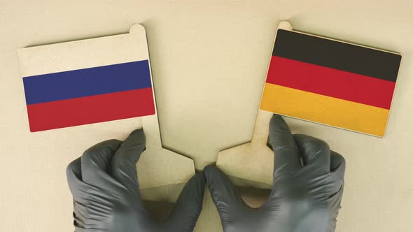 Flags of Russia and Germany Made of Cardboard on the Desk