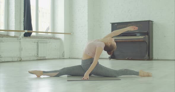 Fit Woman Doing Front Split with Right Leg Forward