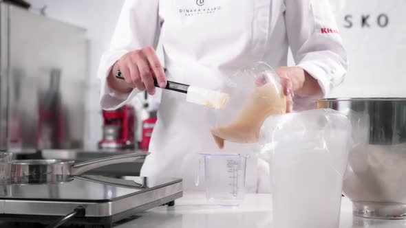 Pastry Chef Prepares Mousse for the Signature Cake