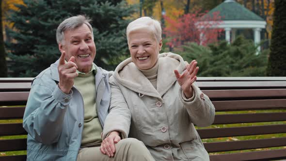 Caucasian Married Couple Family Retired 60s People Man Woman Waving Hands Hello Goodbye Gesture