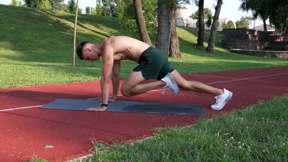 Athlete Guy Working on His Sixpacks with Rock Mountain Exercise on Fitness Mat Sport Success