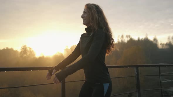 Young Muscular Fitness Woman Doing Squats Exercise in the Nature.