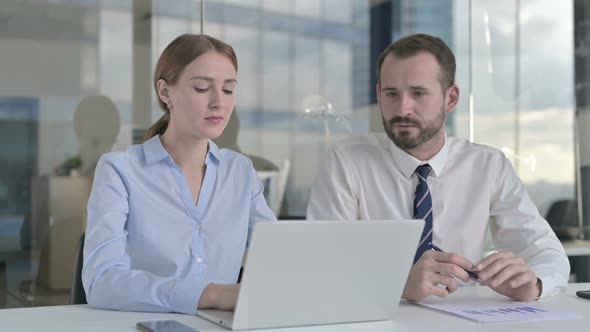 Executive Business People Discussing Project on Laptop Screen