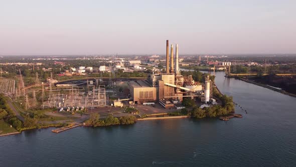 DTE Electric Company Rouge River Coal Power Plant From River In Michigan, USA. - aerial ascend