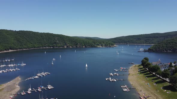 Woffelsbach lake with sailboats. Bushy and hilly landscape