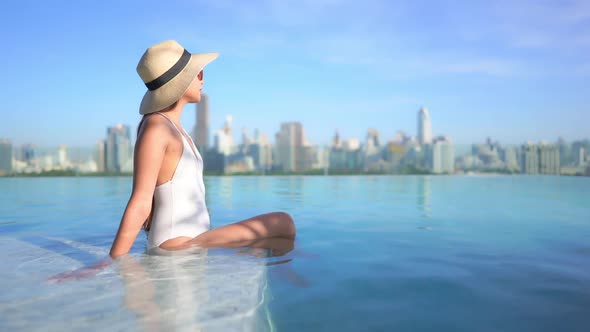 Young asian woman enjoy around outdoor swimming pool for leisure