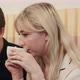 Portrait of Young Couple Talking Seriously and Drinking Coffee at a Coffee Shop - VideoHive Item for Sale