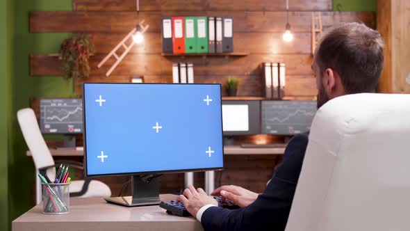 Back View of Businessman Typing on Computer with Mock-up