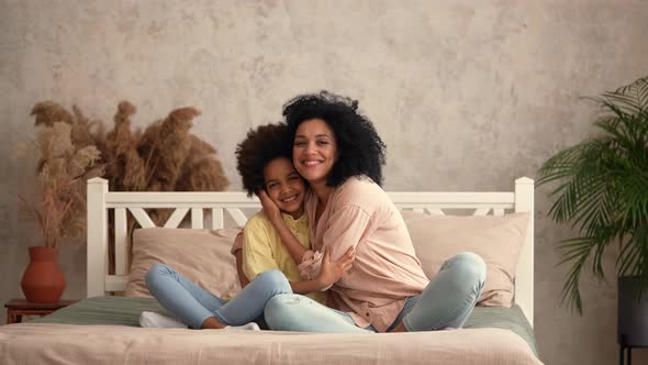 African American Woman and Little Girl are Hugging Each Other and Have Fun Talking