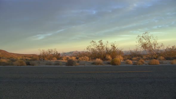 Male running along road at sunset