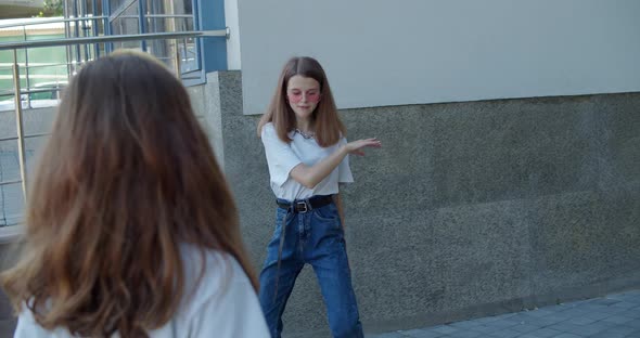 Stylish Young Girls in Sunglasses Dancing on Leisure Outdoors on Background