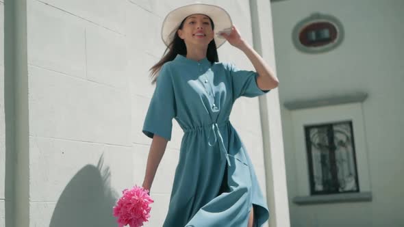 Happy Stylish Charming young mixed race woman Fashion Blogger Walking Along European Urban Street in