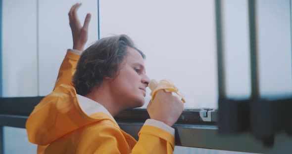 Young man looking out of a high window