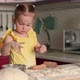 A Little Girl Prepares Pastries From Dough and Flour at Home in the Kitchen - VideoHive Item for Sale