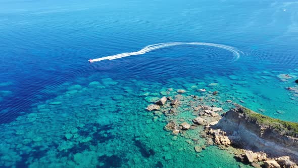 Aerial View of a Motor Boat Towing a Tube. Zakynthos, Greece