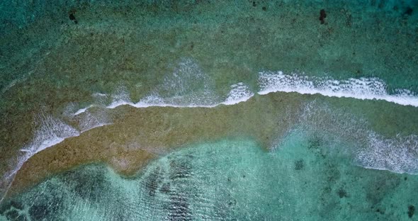 Tropical flying abstract shot of a sandy white paradise beach and aqua turquoise water background 