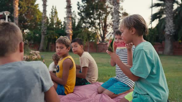 Four School Children Eating Watermelon Outdoor at Summer Time Happy Summer Concept