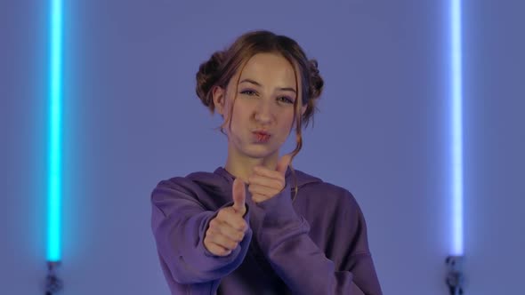 Portrait of Young Attractive Woman Smiling and Showing Thumbs Up Gesture