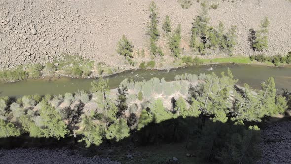 Broken Crumbled Rocks Spilling From the Narrow Canyon Slope Ridge Towards the Deep Valley Floor