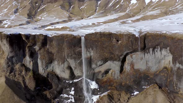 Small and Beautiful Waterfall on a Snowcapped Mountain in the Winter