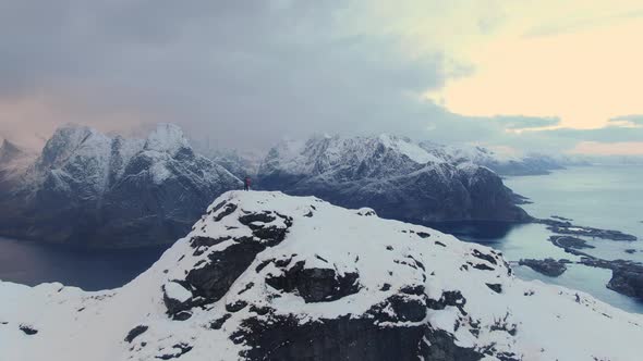 Drone Over Lone Hiker On Snowy Mountain