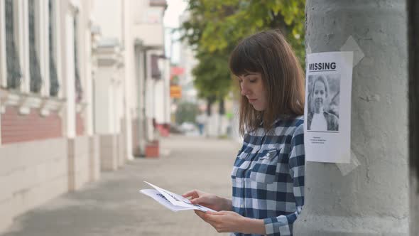 Girl Volunteer Handing Out Leaflets About the Missing Child