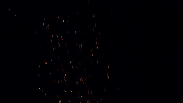 Burning Redhot Sparks Rise From Large Fire in the Night Sky in Slow Motion