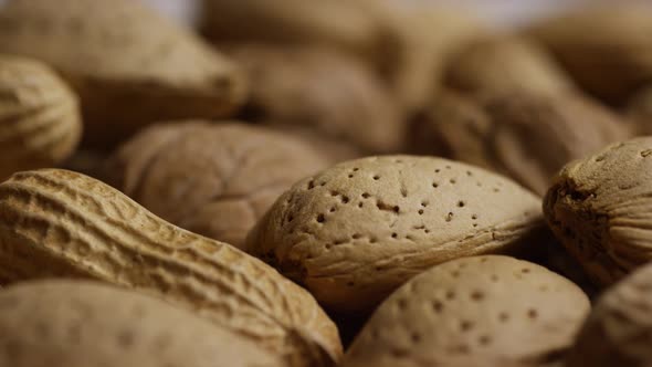 Cinematic, rotating shot of a variety of nuts on a white surface - NUTS MIXED 037