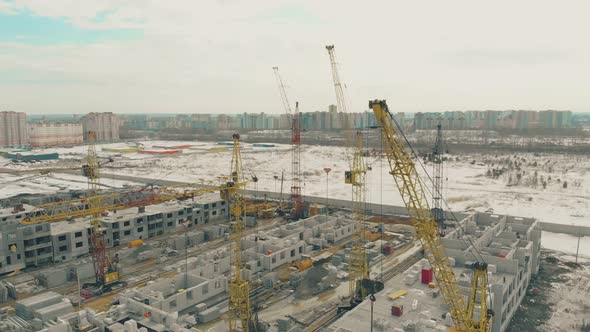 Tower Cranes at Construction Site on Winter Day Upper View