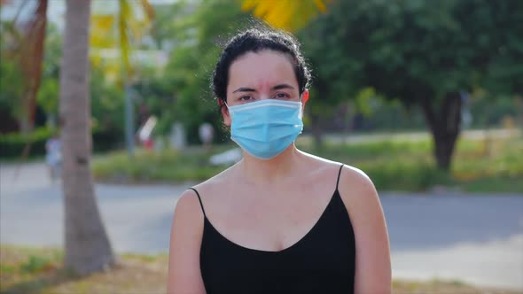Portrait of a Young Woman in a Mask From a Coronavirus Epidemic Is Wearing Protective Ask on Street