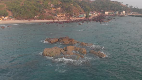 Waves gently crashing on sea rocks, Arambol beach , Goa, India. Aerial view 