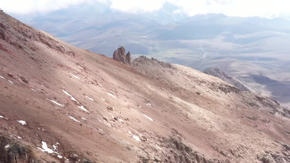 Aerial view flying over the slopes of the vulcano chimborazo towards the whymper needles