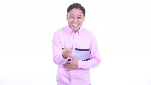 Happy Japanese Businessman Laughing and Pointing at Camera